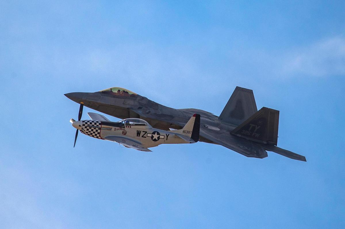 During a heritage flight, a World War II aircraft flies alongside the Raptor F-22 during the AllianceTexas Aviation Expo presented by Bell at the Fort Worth Alliance Airport in Fort Worth on Saturday, Oct. 22, 2022. A trio of performances capped off the airshow in its 33rd year of running.