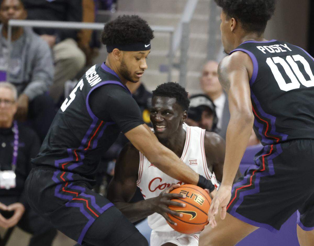 TCU forward Micah Robinson (5) ties Houston forward Kalifa Sakho (14) up in their offensive corner during the first half of a NCAA basketball game between the University of Houston and TCU at Schollmaier Arena in Fort Worth, Texas, Wednesday Jan. 26, 2026