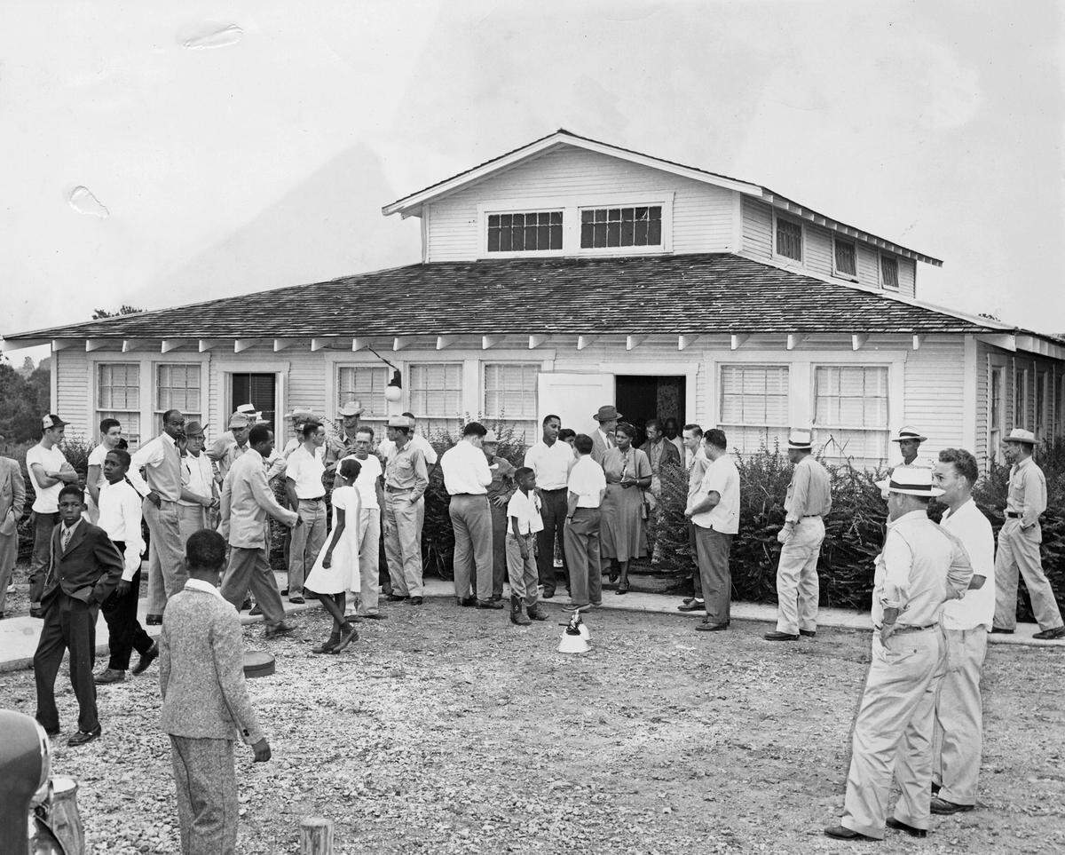 A crowd mills around a Euless school after a group of Black parents tried to enroll their children there. The children were refused. Their leader said later they had not expected to gain admission, but hoped to get improvements for the school for Black children.