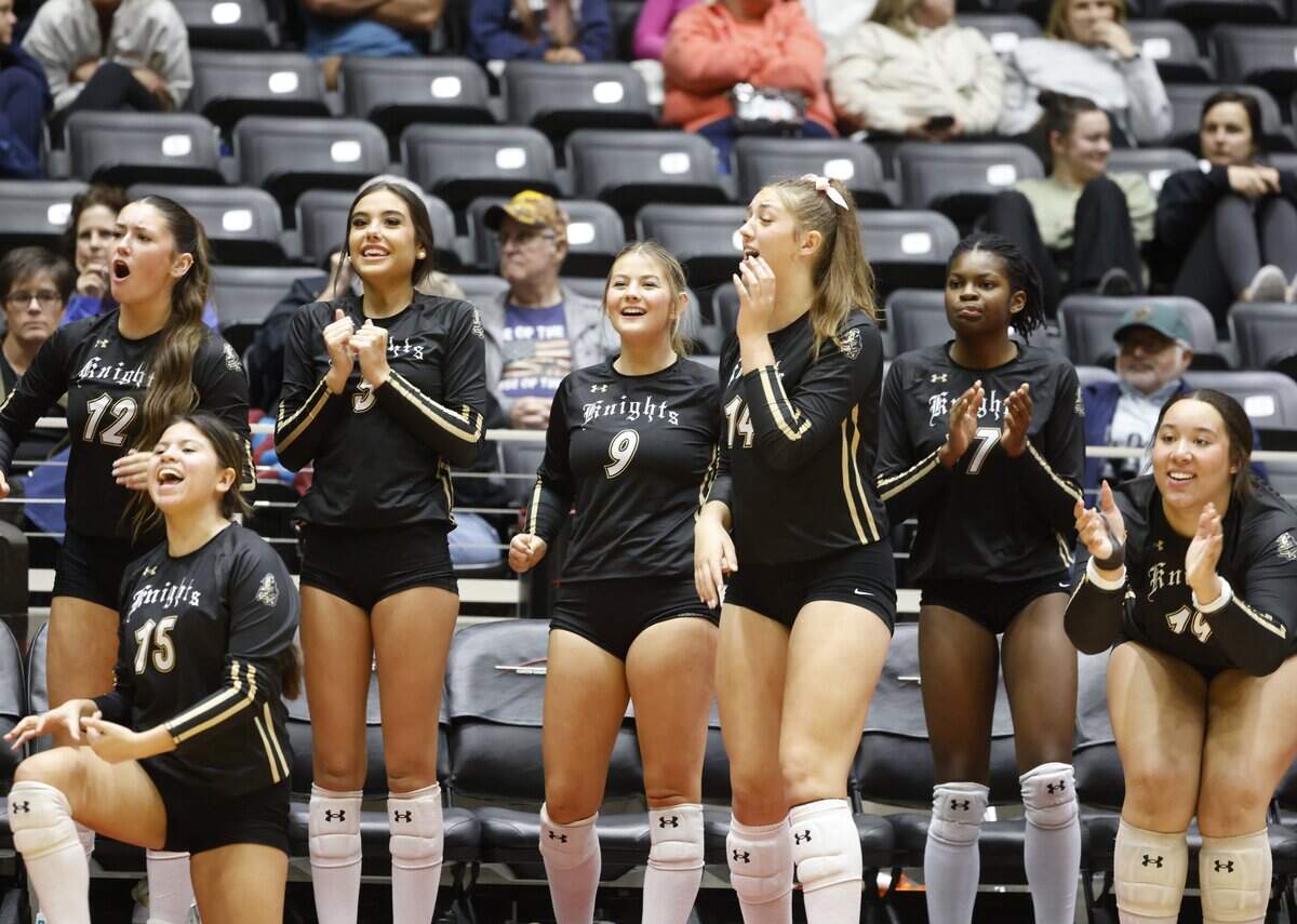 The Fort Worth Eagle Mountain Lady Knights’ bench celebrates a point against Wimberley during the third set of the UIL Class 4A Division II state volleyball championship game Friday Nov. 21, 2025 at Curtis Culwell Center in Garland, Texas.