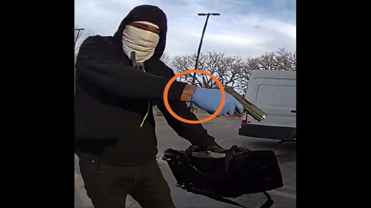 A still from body-camera footage shows Laroyce Antoine Lambert pointing a handgun at a security guard servicing a Chase Bank ATM in Balch Springs, Texas, prosecutors said. Lambert was arrested on a federal charge after he was accused of shooting the guard.