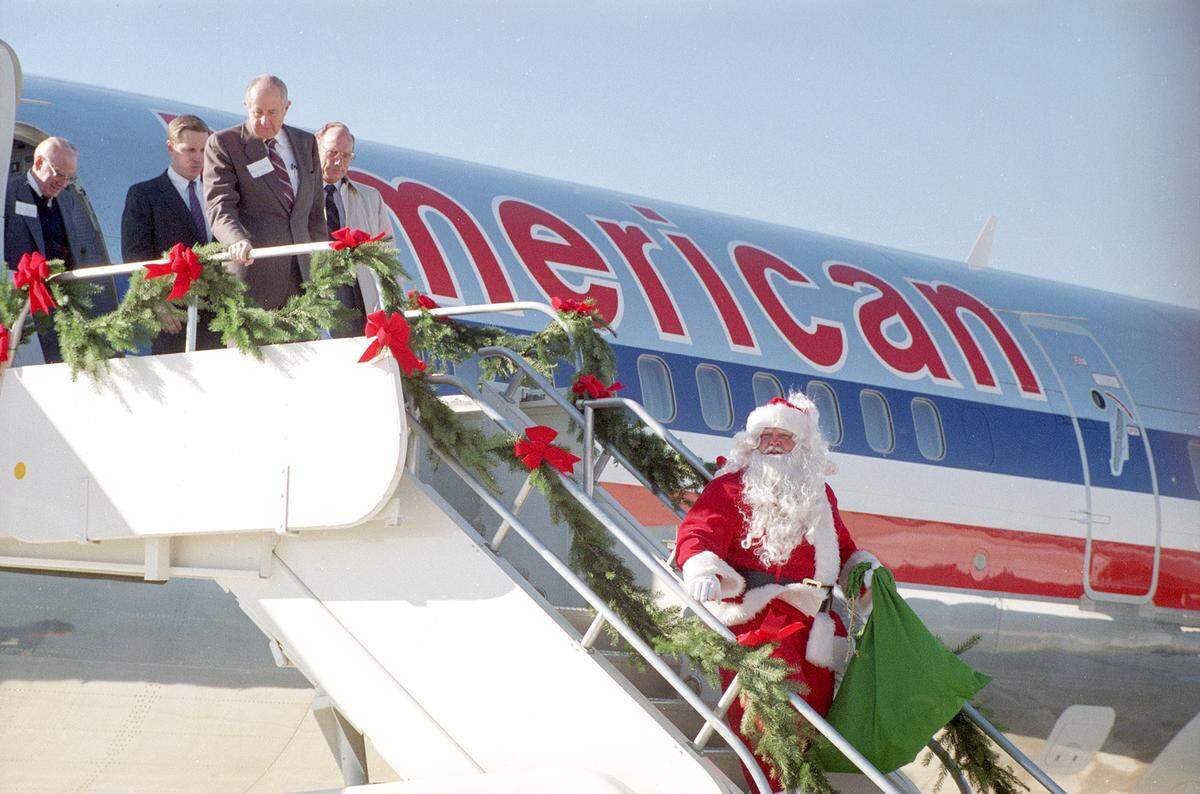 Dec. 14, 1989: Santa is the first passenger to step off an American Airlines Boeing 757 that lands during inauguration ceremonies for the new $35 million Alliance Airport in Fort Worth. Elementary school students await at the bottom of the stairs.