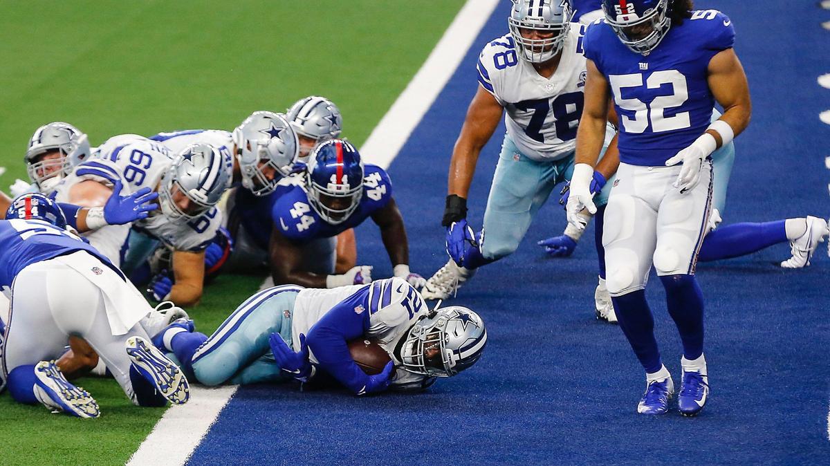 Dallas Cowboys running back Ezekial Elliott leaps into the end zone for a touchdown against the New York Giants in the second quarter of Sunday’s game at AT&T Stadium.