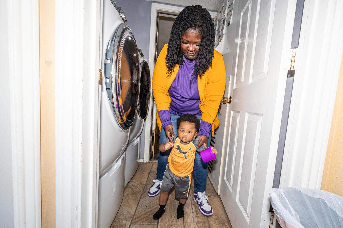 Child care center director Roslyn Chaney guides her infant student Kingston Wooten to the infant sleeping area in the evening at the Future Scholars’ Childcare and Transportation child care home in Grand Prairie on Thursday, March 14, 2024. Future Scholars’ is one of few programs in Tarrant County that provide 24/7 child care.