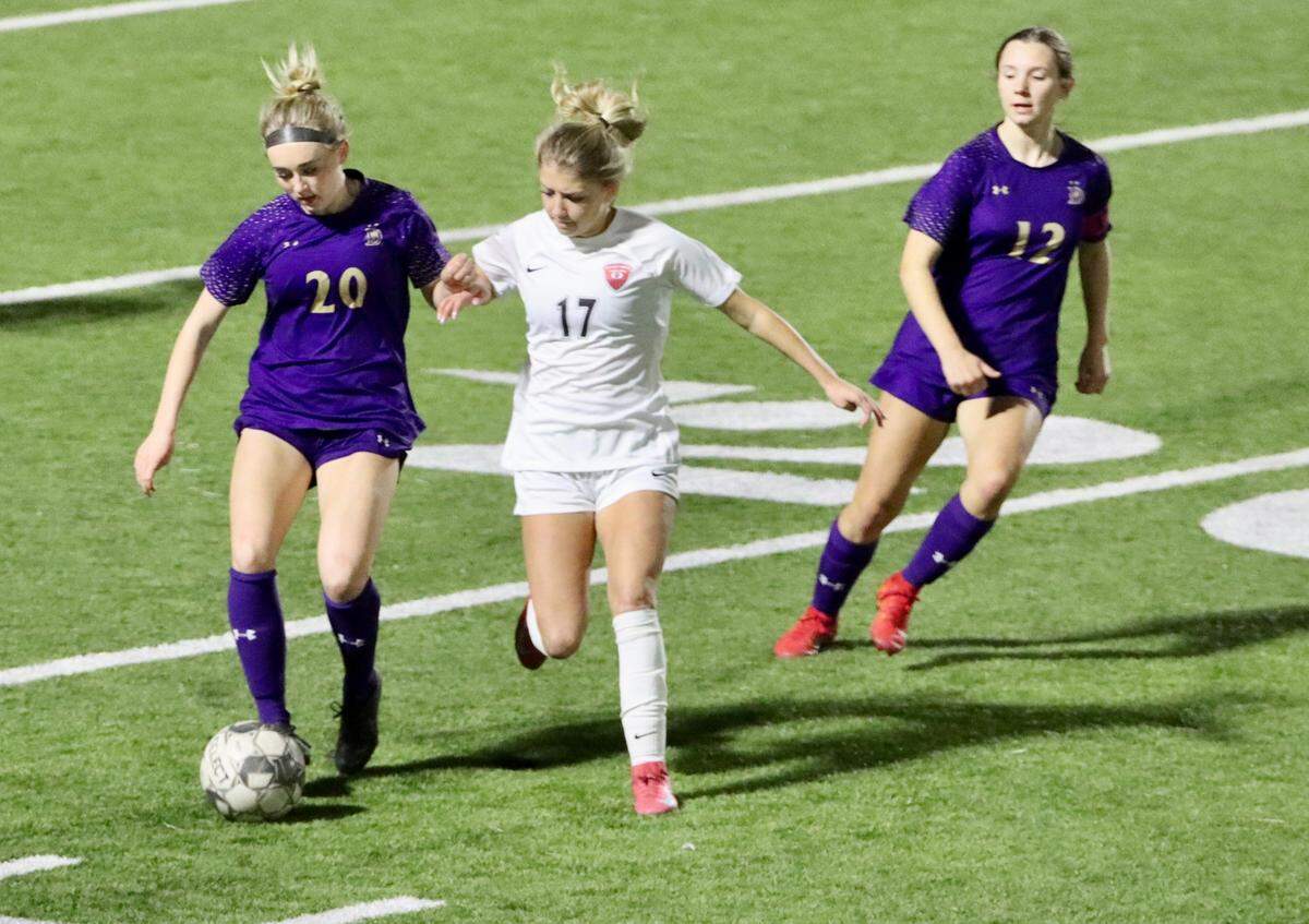 Sophomore forward Addison Shimmick fights for possession during a district game vs. at Denton High School in Denton, Texas on Friday, Feb. 28, 2025.