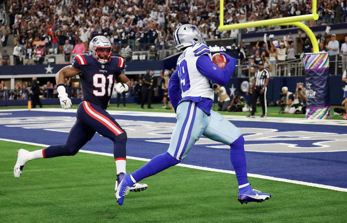 Dallas Cowboys defensive tackle Chauncey Golston runs the ball into the end zone for a two-point conversion while being pursued by New England Patriots’ Deatrich Wise Jr. on Sunday, October 1, 2023, at AT&T Stadium in Arlington.