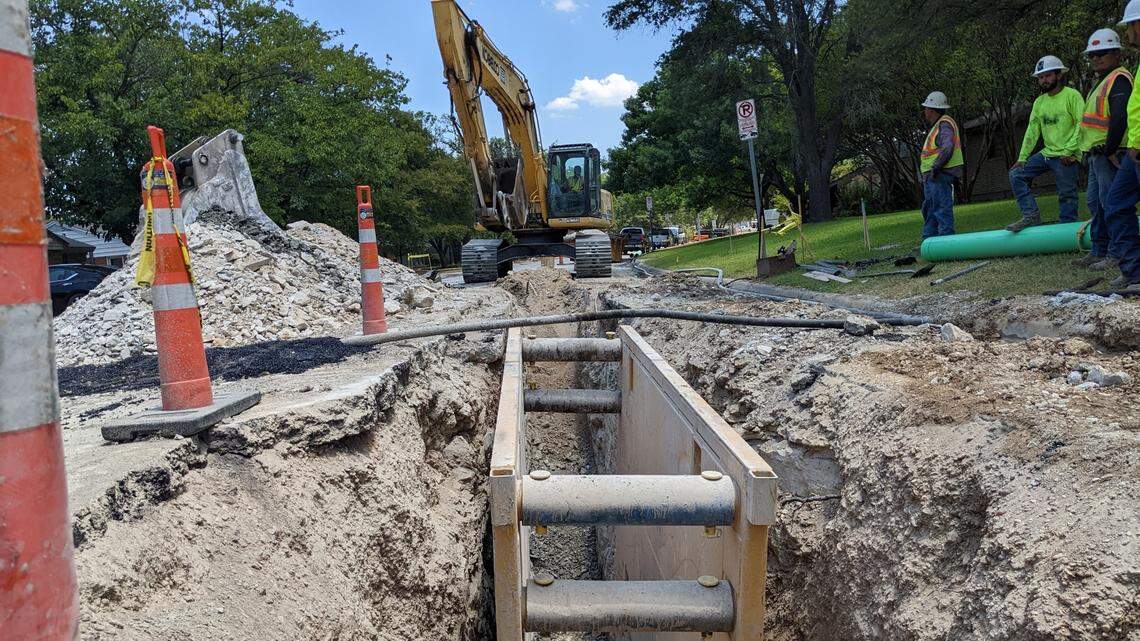 A construction crew replacing an aging water pipe.