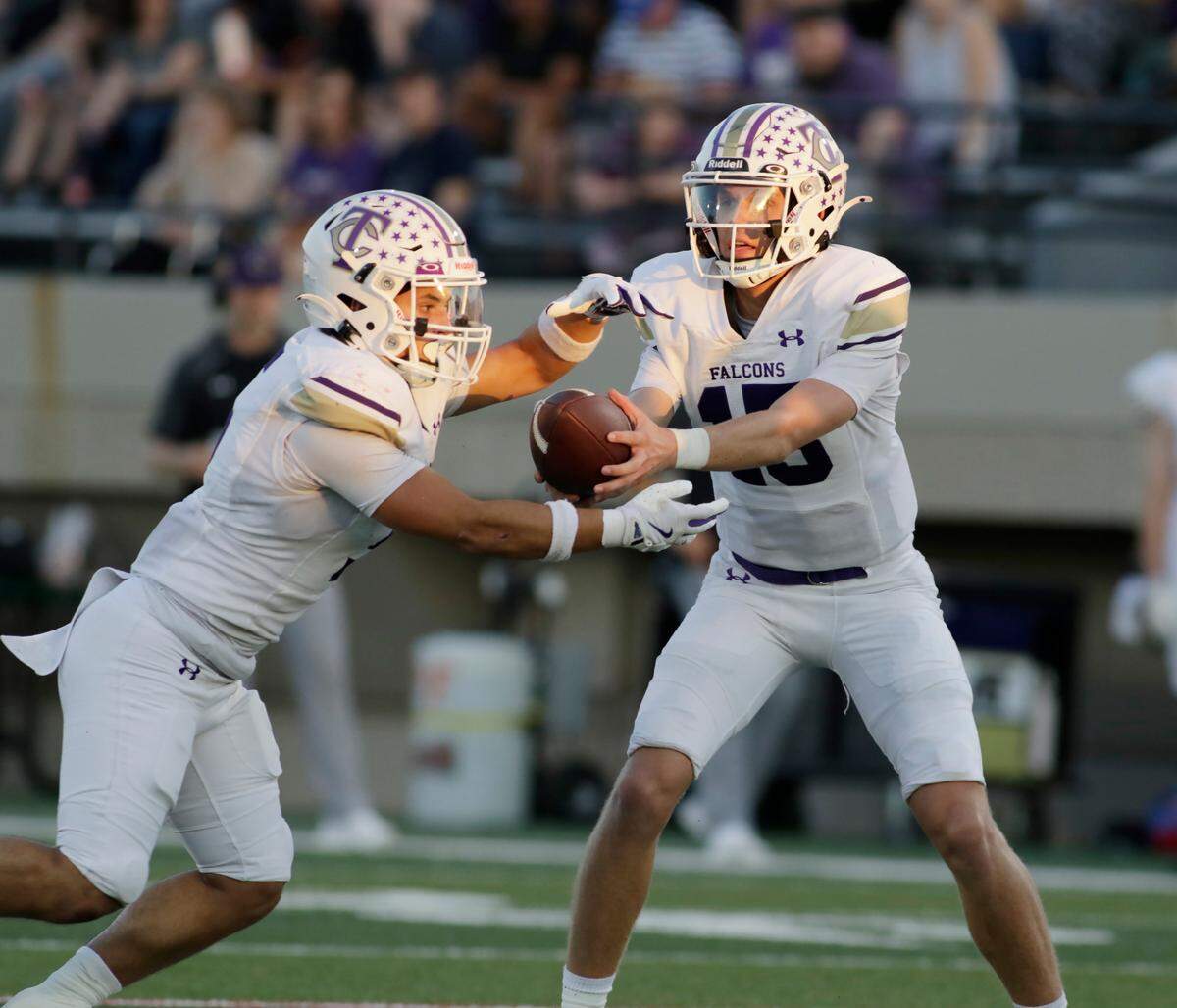 Timber Creek’s Carson Porter hands off to Tony Hoagland during their UIL football game Friday night at Pennington Field in Hurst on Friday Sept. 6, 2024.