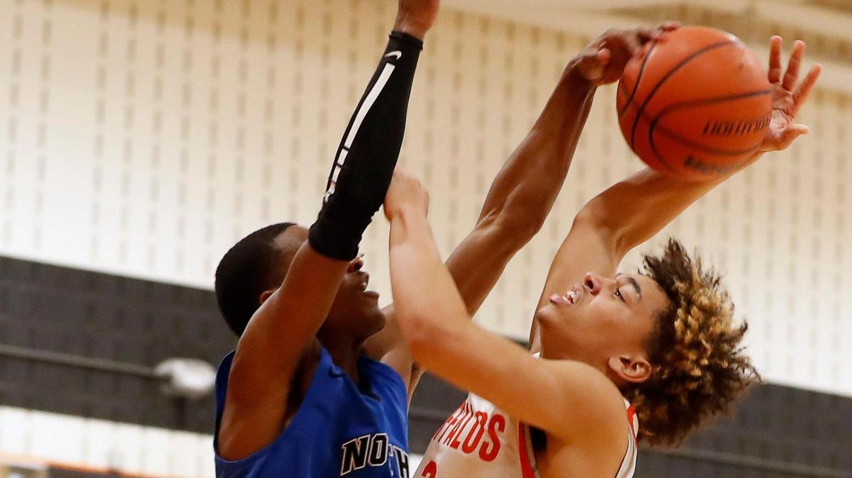 North Crowley guard Malik Clinton (3) blocks the shot of Haltom guard Kyron Powell (2) during a District 3-6A Bi-district basketball game at Haltom High School in Haltom City, Texas, Friday, Feb. 12, 2021. North Crowley defeated Haltom 55-45. (Special to the Star-Telegram Bob Booth)
