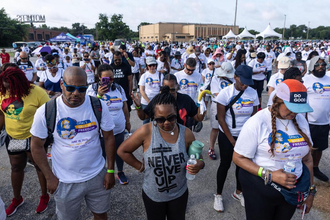 Walk participants bow their heads in prayer prior to the Opal Lee Walk for Freedom at Farrington Field in Fort Worth on Thursday, June 19, 2025.