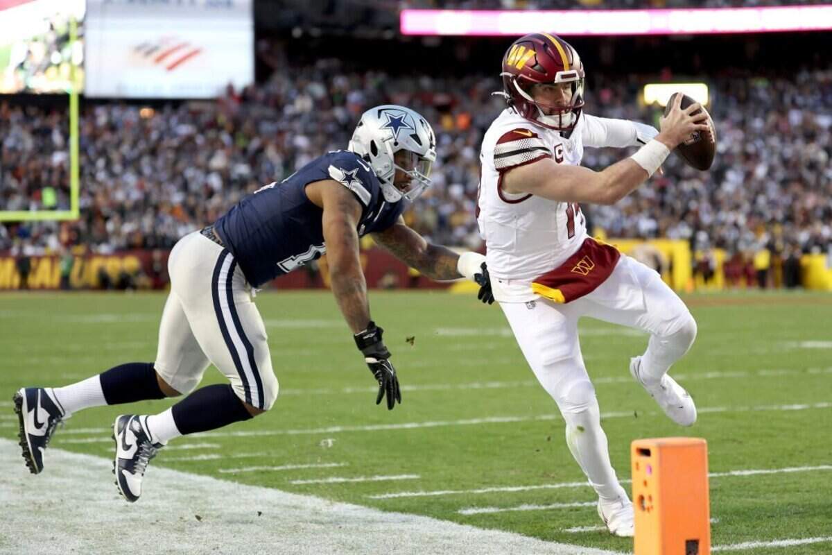 LANDOVER, MARYLAND - JANUARY 07: Sam Howell #14 of the Washington Commanders runs with the ball during the first half against the Dallas Cowboys at FedExField on January 07, 2024 in Landover, Maryland. (Photo by Scott Taetsch/Getty Images)