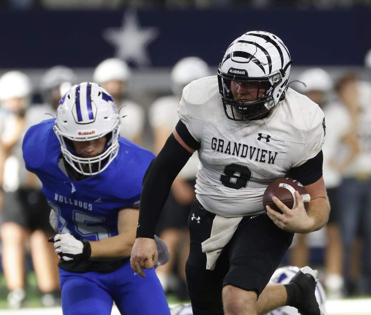Grandview quarterback Mason Landers (8) gains yards against Yoakum and middle linebacker Colby Jendrzey (15) during the first half of a UIL Class 3A Division I championship game on Thursday Dec. 18, 2025 at AT&T Stadium in Arlington, Texas.