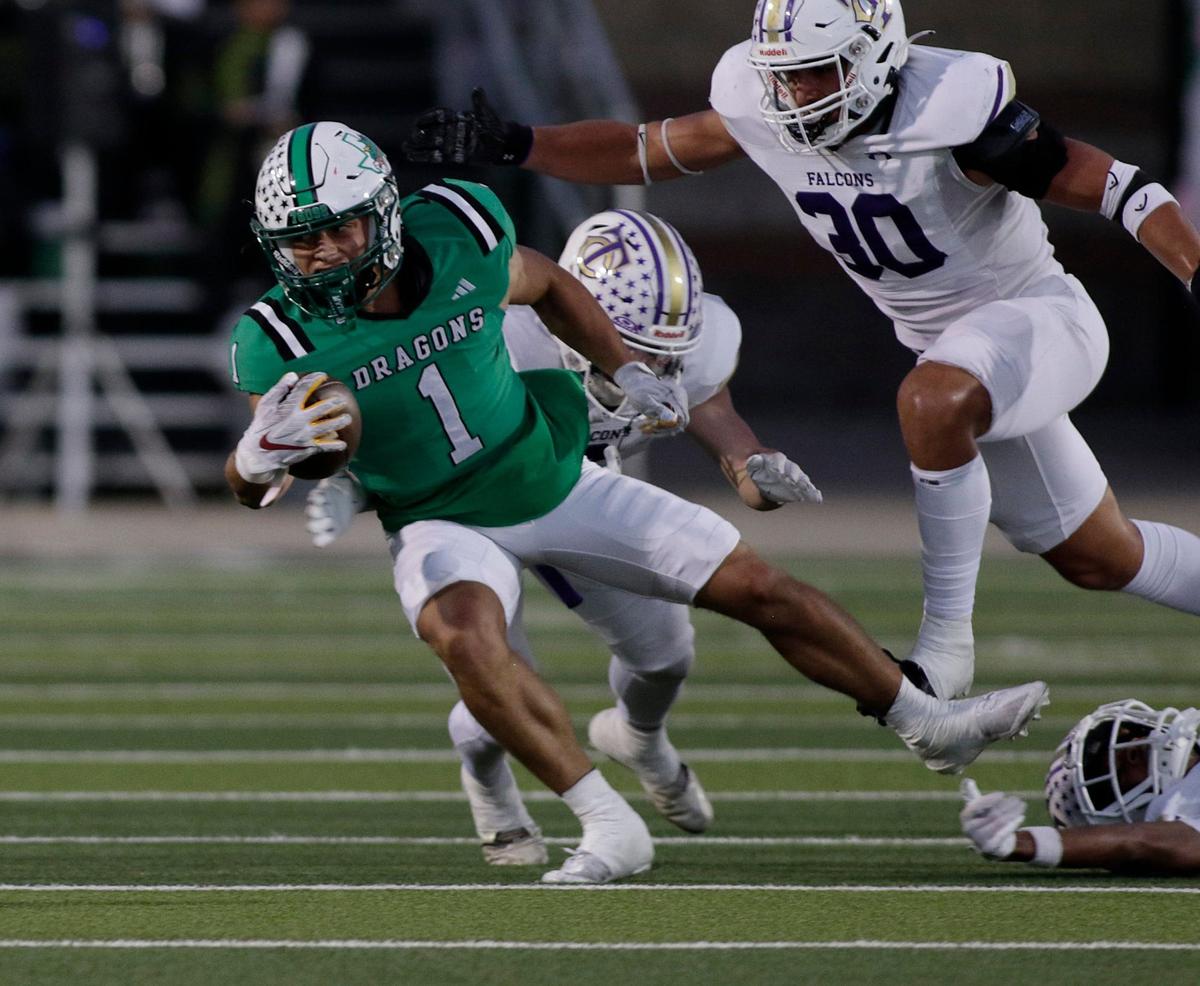 Southlake Carroll’s Riley Womley breaks a tackle during a UIL football game at Dragon Stadium on Friday, Sept. 27, 2024.
