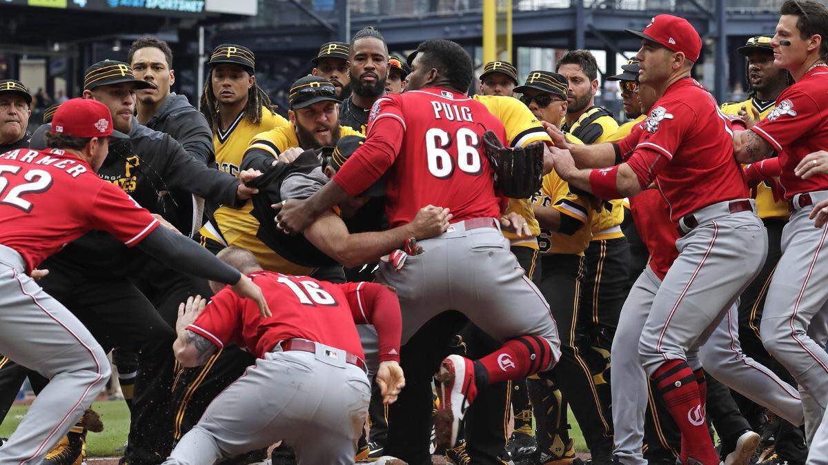 Cincinnati Reds’ Yasiel Puig (66) pulls away from Tucker Barnhart (16) as he attempts to re-enter a bench clearing during the fourth inning of a baseball game against the Pittsburgh Pirates in Pittsburgh, Sunday, April 7, 2019. (AP Photo/Gene J. Puskar)