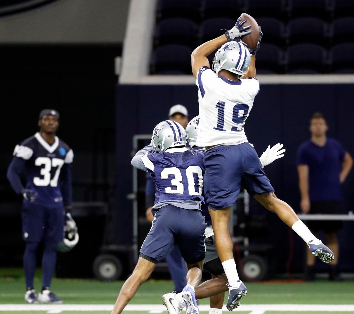 Dallas Cowboys wide receiver Amari Cooper (19) goes over the head of cornerback Anthony Brown (30) for a catch during the Dallas Cowboys final minicamp before spring training at The Star in Frisco, Texas, Thursday, June 13, 2019. (Special to the Star-Telegram Bob Booth)
