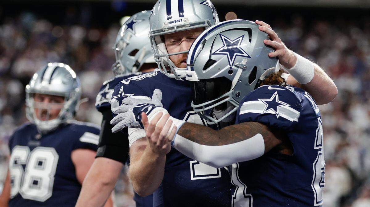 Dallas Cowboys running back Ezekiel Elliott (21) celebrates with Dallas Cowboys quarterback Cooper Rush (10) after scoring a touchdown against the New York Giants during the third quarter of an NFL football game, Monday, Sept. 26, 2022, in East Rutherford, N.J. (AP Photo/Adam Hunger)