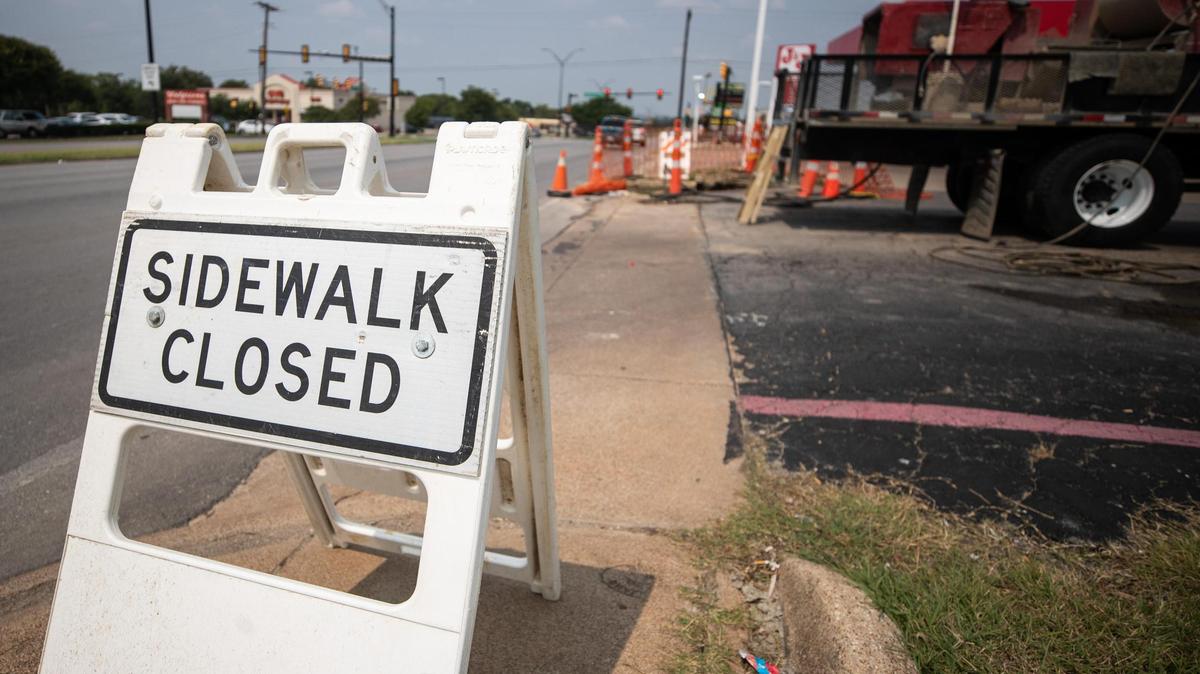 Sidewalk repairs are in progress along Lancaster Avenue in Fort Worth. The city expects to spend $2 billion in five years to fix infrastructure.