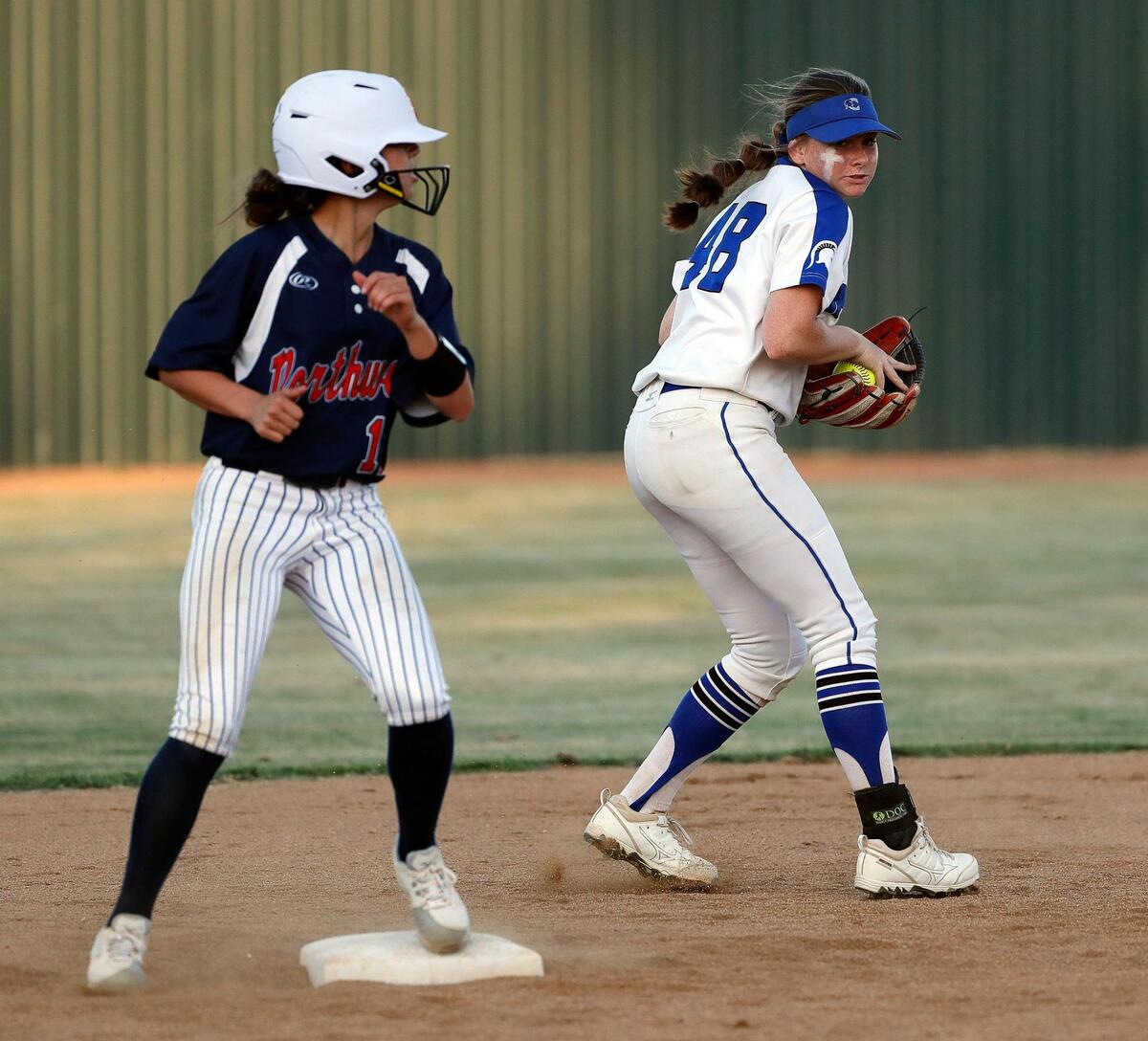 Northwest’s Alexah Reyes (17) celebrates reaching second on a wild pitch to first and late throw to Burleson Centennial second baseman Madison Haynes (48) during a UIL 5A Region 1 quarter-final playoff softball name at Spartans Softball Field in Mansfield, Texas, Wednesday, May 11, 2022. Centennial defeated Northwest 7-5 in game one. Game two will be at Northwest High School Thursday with game three at Weatherford High School if necessary. (Special to the Star-Telegram Bob Booth)