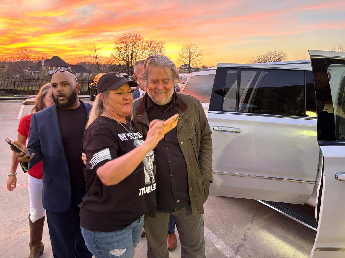 Waxahachie resident Christie Autrey takes a selfie with Steve Bannon after his speech.