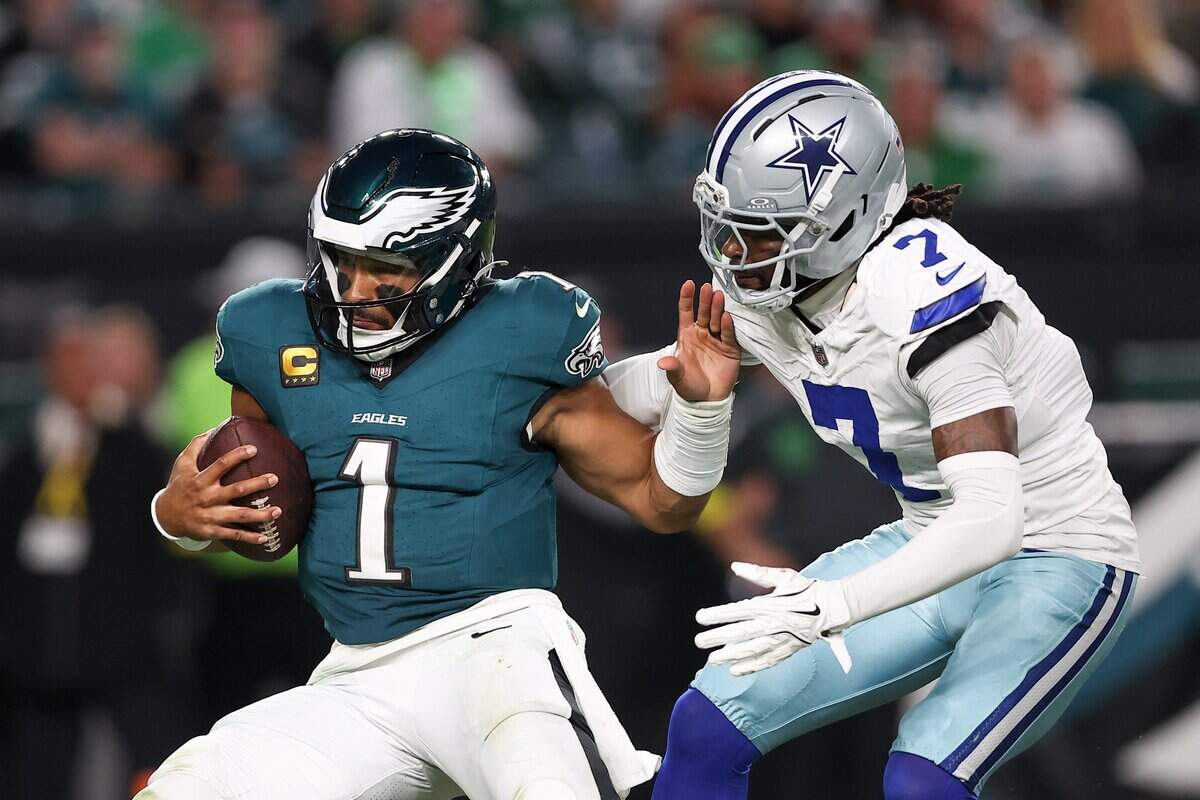 Sep 4, 2025; Philadelphia, Pennsylvania, USA; Dallas Cowboys cornerback Trevon Diggs (7) tackles Philadelphia Eagles quarterback Jalen Hurts (1) during the third quarter of the game at Lincoln Financial Field. Mandatory Credit: Bill Streicher-Imagn Images