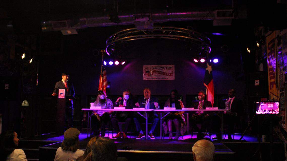 Eric Mahroum, left moderates an Arlington mayor candidate forum at Mavericks Bar and Grill on Thursday. Candidates at the forum, from left to right: Jerry Warden, Dewayne Washington, Jim Ross, Doni Anthony, Michael Glaspie and Kelly Burke.