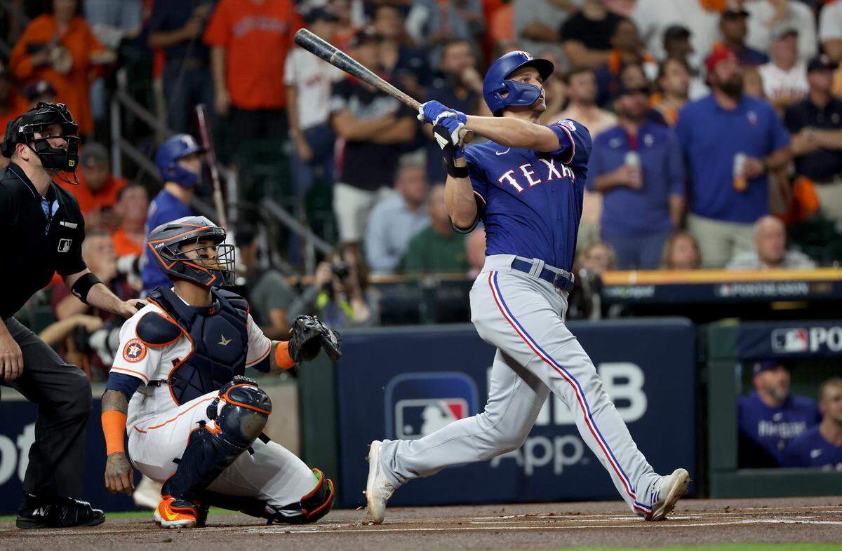 Texas Rangers shortstop Corey Seager (5) hits a home run during the first inning of game seven in the ALCS against the Houston Astros for the 2023 MLB playoffs at Minute Maid Park.