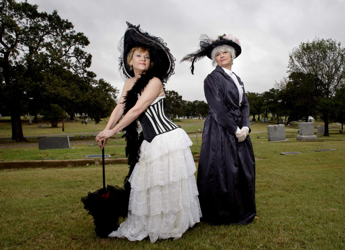 Donna Donnell, left, and Marty Humphrey, dressed in period costumes, will serve as tour guides at the historic Oakwood Cemetery “Saints and Sinners Tour” in October 2007.