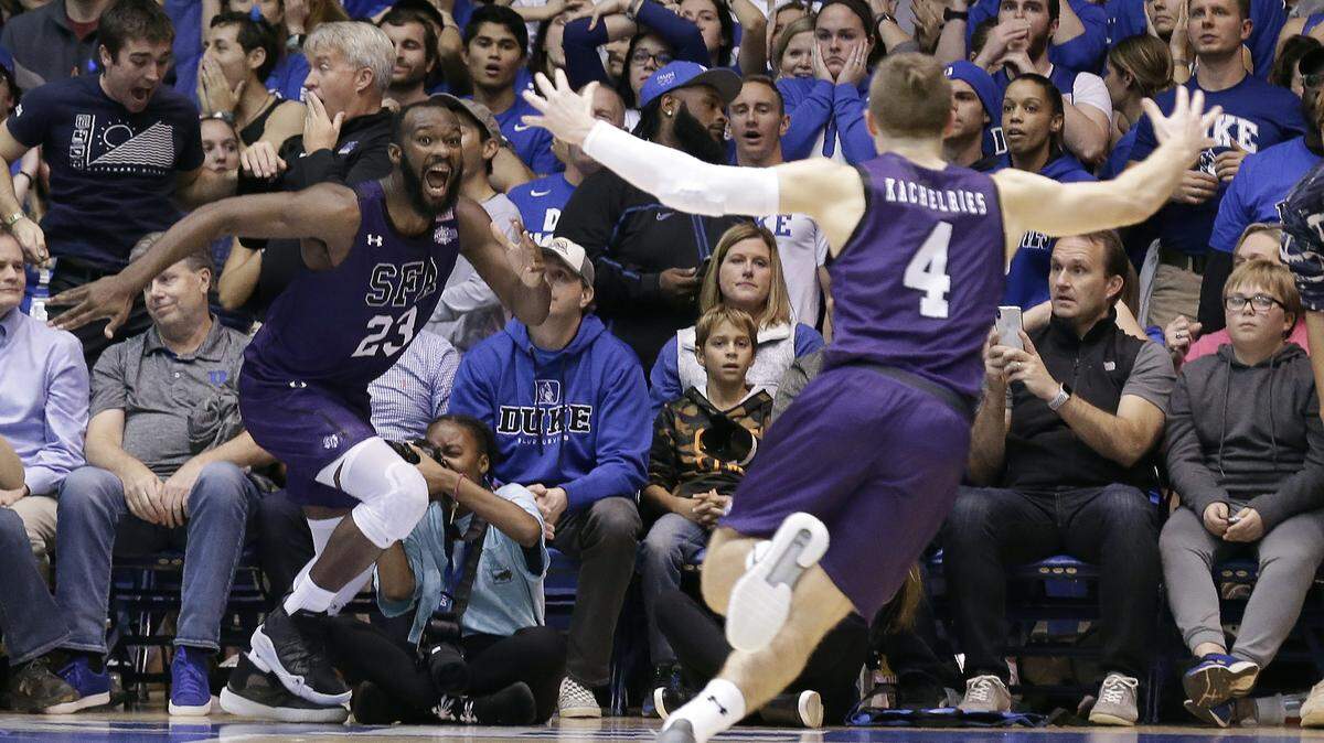 Stephen F. Austin forward Nathan Bain (23) and guard David Kachelries (4) celebrate Bain’s game winning basket against Duke in overtime of an NCAA college basketball game in Durham, N.C., Tuesday, Nov. 26, 2019. (AP Photo/Gerry Broome)