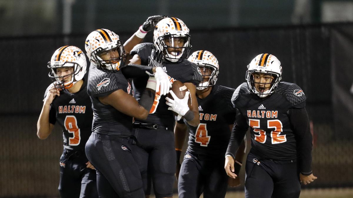 Team mates celebrate with Haltom wide receiver Julian Johnson (8) after his touchdown during the first half of a high school Bi-district football playoff game at Birdville FAAC in North Richland Hills, Texas, Thursday, Nov. 16, 2018. Bowie led 28-25 at the half. (Star-Telegram Bob Booth)

