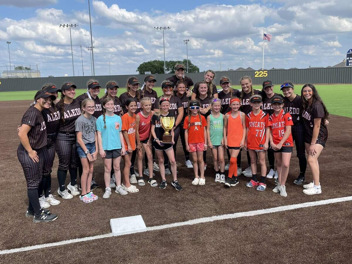 Aledo beat Justin Northwest in the Class 5A Region 1 final Saturday May 29, 2021. The Ladycats take pictures after the game with younger softball players from Aledo.