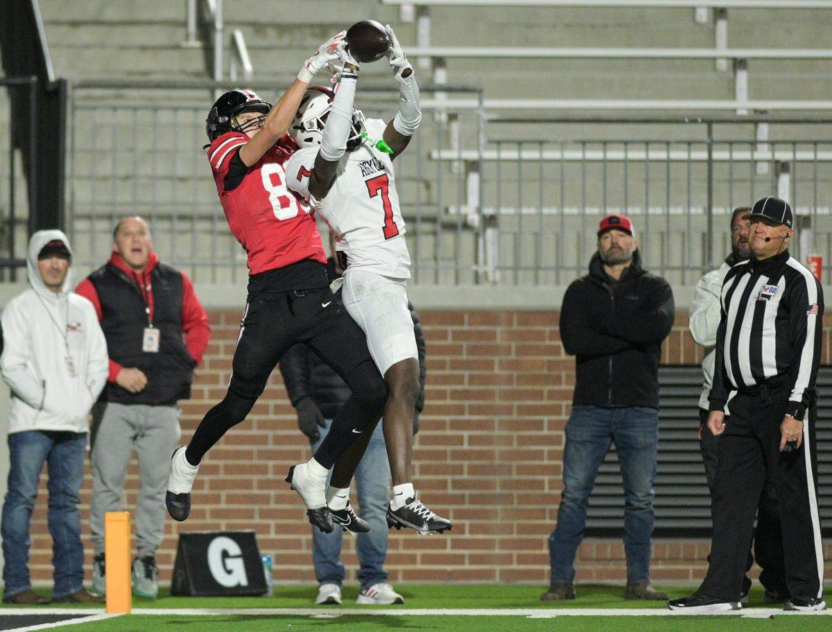 Argyle defensive back Maliek Bracy (7) intercepts the ball as a Lovejoy wide receiver leaps for the catch during the Class 5A Division II Region I playoff game against Lovejoy High School at Prosper ISD Children’s Health Stadium in Prosper, Texas on Friday, Dec. 6, 2024.