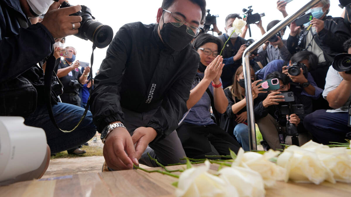Seksan Sriraj, 28, lays flowers during a ceremony for those killed in the attack on the Young Children’s Development Center in the rural town of Uthai Sawan, north eastern Thailand on Friday. Seksan lost his pregnant wife who was a teacher at the day care center when it was attacked by a former policeman Thursday.