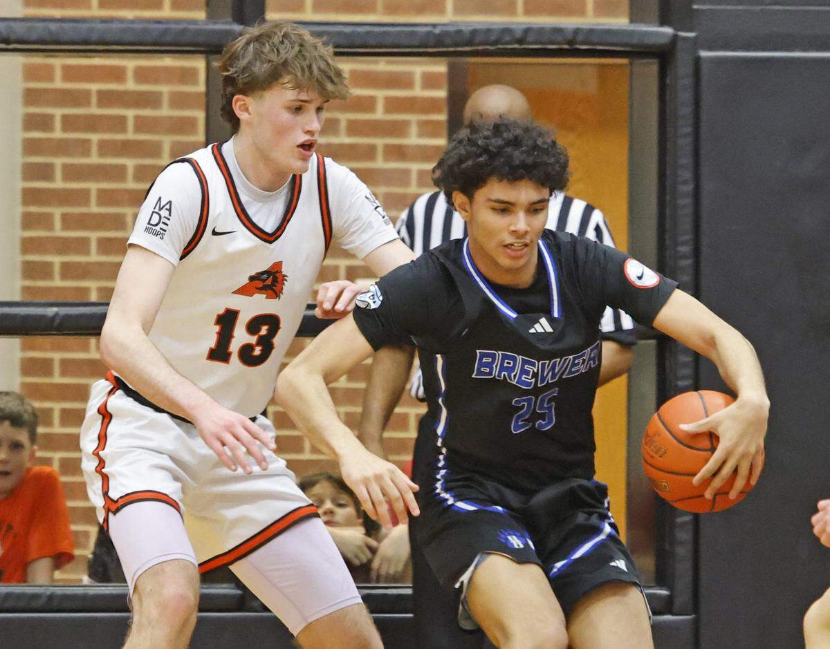 Brewer guard Carter Scott (25) grabs a ball in front of Aledo center Townes VanHuysen (13) during the second half of a UIL boys basketball game at Aledo High School in Aledo, Texas, Friday Feb. 13, 2026.