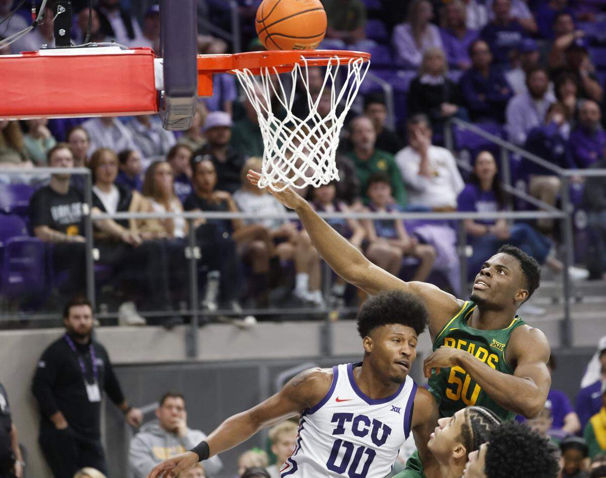 Baylor center James Nnaji (50) watches as TCU guard Jace Posey (00) drops one in for two during the first half of a NCAA basketball game between Baylor University and TCU at Schollmaier Arena in Fort Worth, Texas, Saturday Jan. 03, 2026