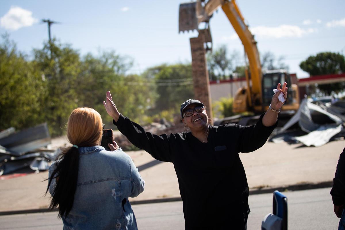 Como residents wave goodbye to an abandoned car wash as it ss demolished Thursday on Horne Street in Fort Worth.