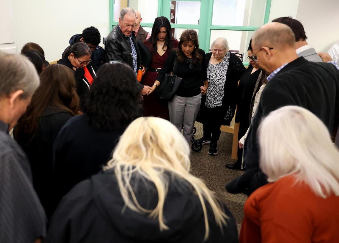 Family members of victims pray outside the courtroom before closing arguments are given in the sentencing phase of Jason Thornburg’s trial on Wednesday, Dec. 4, 2024, at the Tim Curry Criminal Justice Center in Fort Worth. Thornburg was convicted of capital murder in the killing of three victims he dismembered and burned in September of 2021.