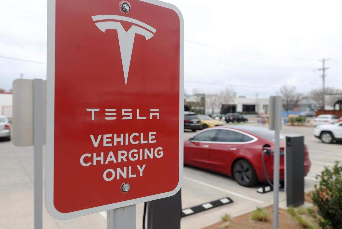 Tesla vehicles charge at a Tesla Supercharger station in the Foundry District in Fort Worth on Tuesday, March 14, 2022. According to a Consumer Reports study from 2020, EVs cost less to fuel and are cheaper to repair and maintain than comparable gasoline-powered models.