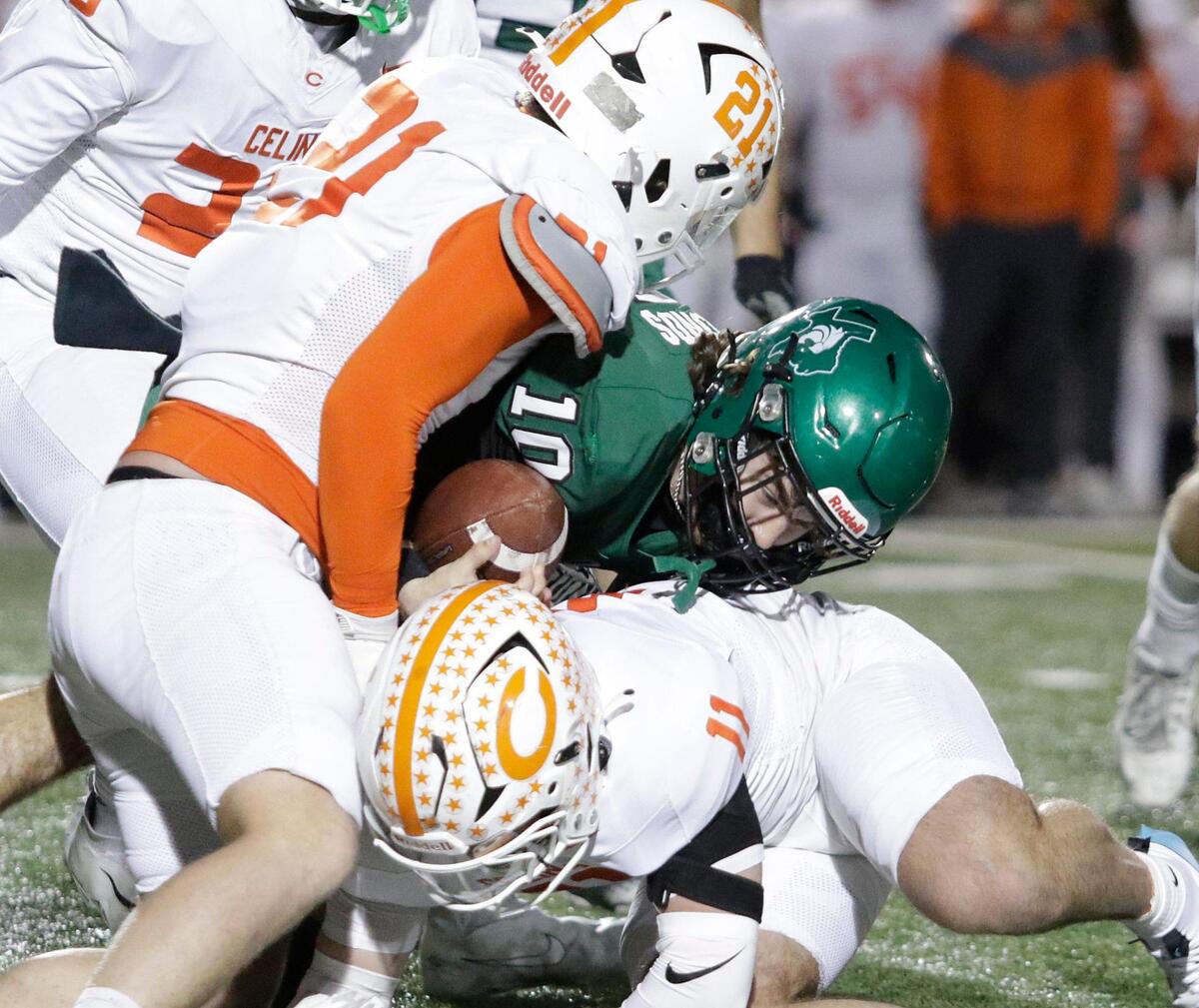Kennedale’s Jackson Hammonds is brought down by Celina’s Ronnie Forman and Luke Biagini during a UIL football playoff game at Pennington Field on Friday November 22, 2024.