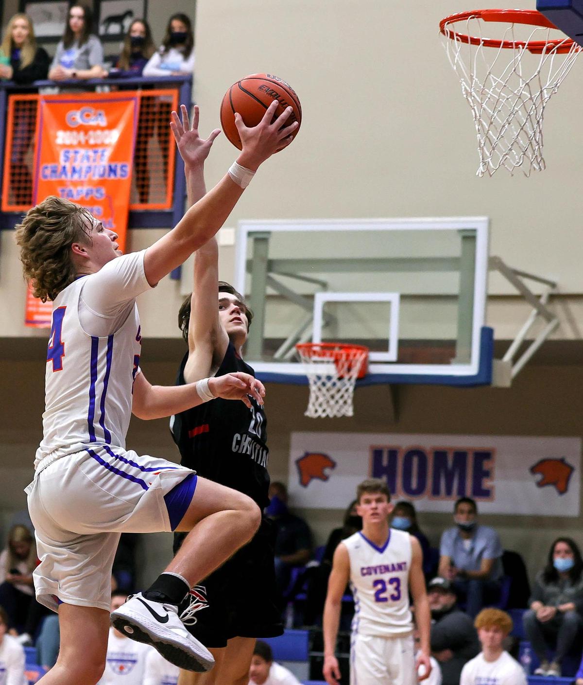 Colleyville Convenant forward Caleb Bunch (24) goes in for two points against Lubbock Trinity forward Parker Sutton (20) during the second half of a High School Basketball game played at Colleyville Convenant High School, January 29, 2021. (Steve Nurenberg Special to the Star-Telegram)