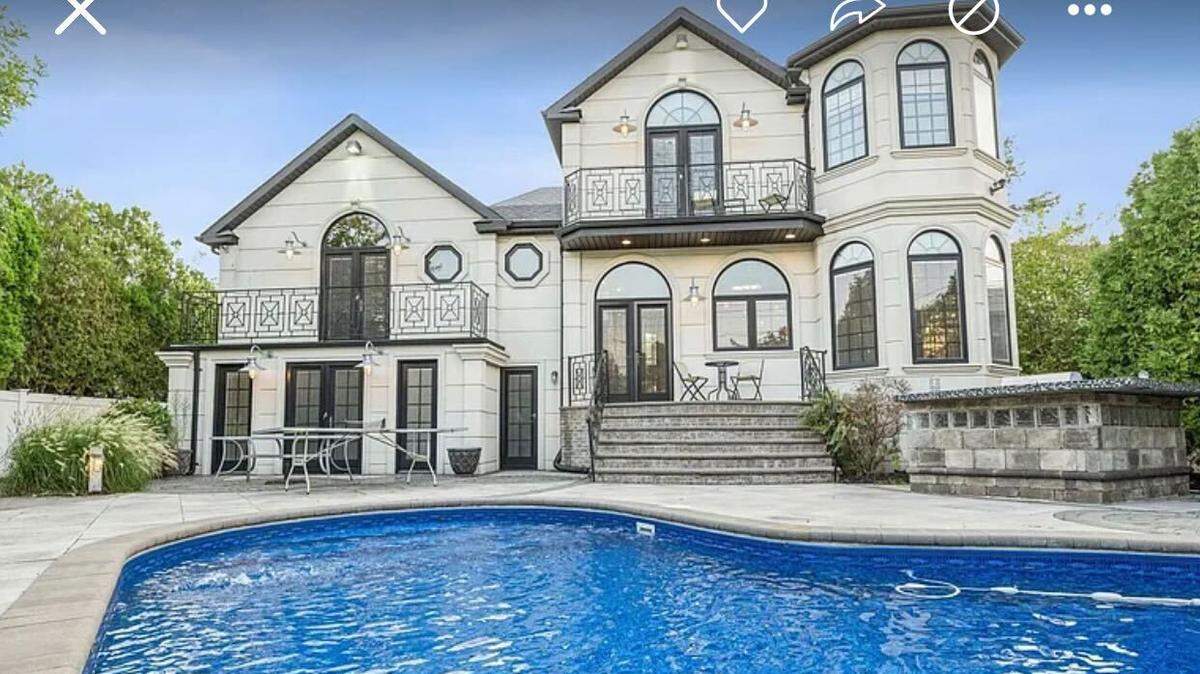 The luxurious home comes with a striking crystal-clear blue in-ground pool.
