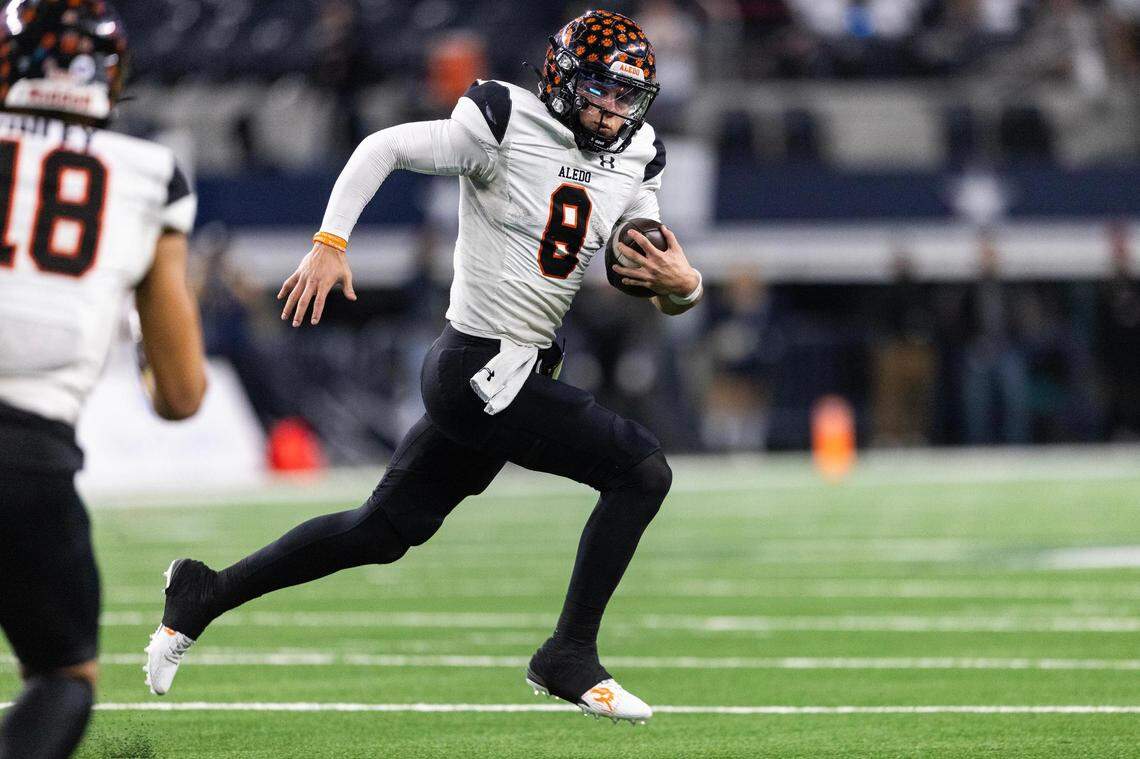 Aledo quarterback Hauss Hejny (8) runs the ball upfield in the second quarter of the 5A Division I football state championship game against the Smithson Valley Rangers at AT&T Stadium in Arlington on Friday, Dec. 15, 2023.