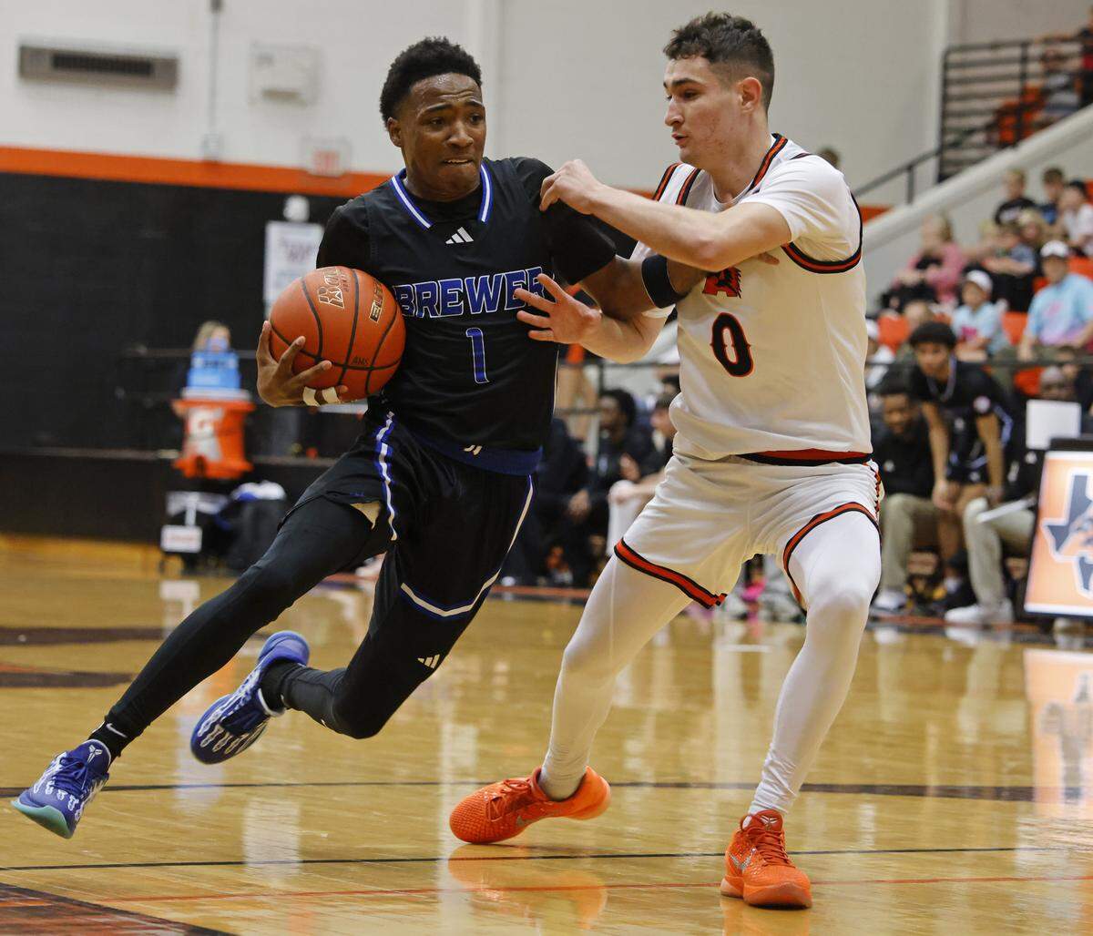 Aledo guard Enrique Pacheco (0) presses Brewer guard Braylen Brown (1) during the first half of a UIL boys basketball game at Aledo High School in Aledo, Texas, Friday Feb. 13, 2026.