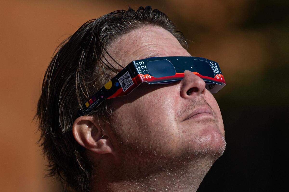 Travis Youngblood looks up to view the eclipse during the Annular Solar Eclipse event at the Fort Worth Museum of Science & History on Saturday, Oct. 14, 2023.