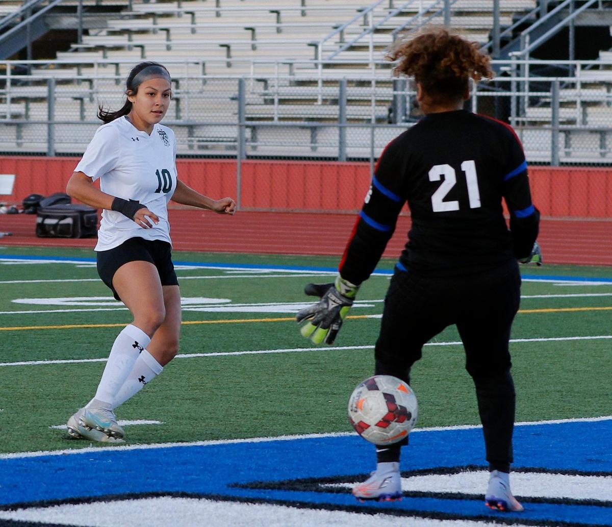 Kennedale’s Angelina Olmos (10) scores the teams third point on Carter Riverside goal tender Veronica Thomas (21) during a 4A Region 1 bi-district girls soccer playoff game at Elk Stadium in Burleson, Texas, Friday, Mar. 25, 2022. Kennedale moves on after defeating Carter Riverside 5-1. (Special to the Star-Telegram Bob Booth)