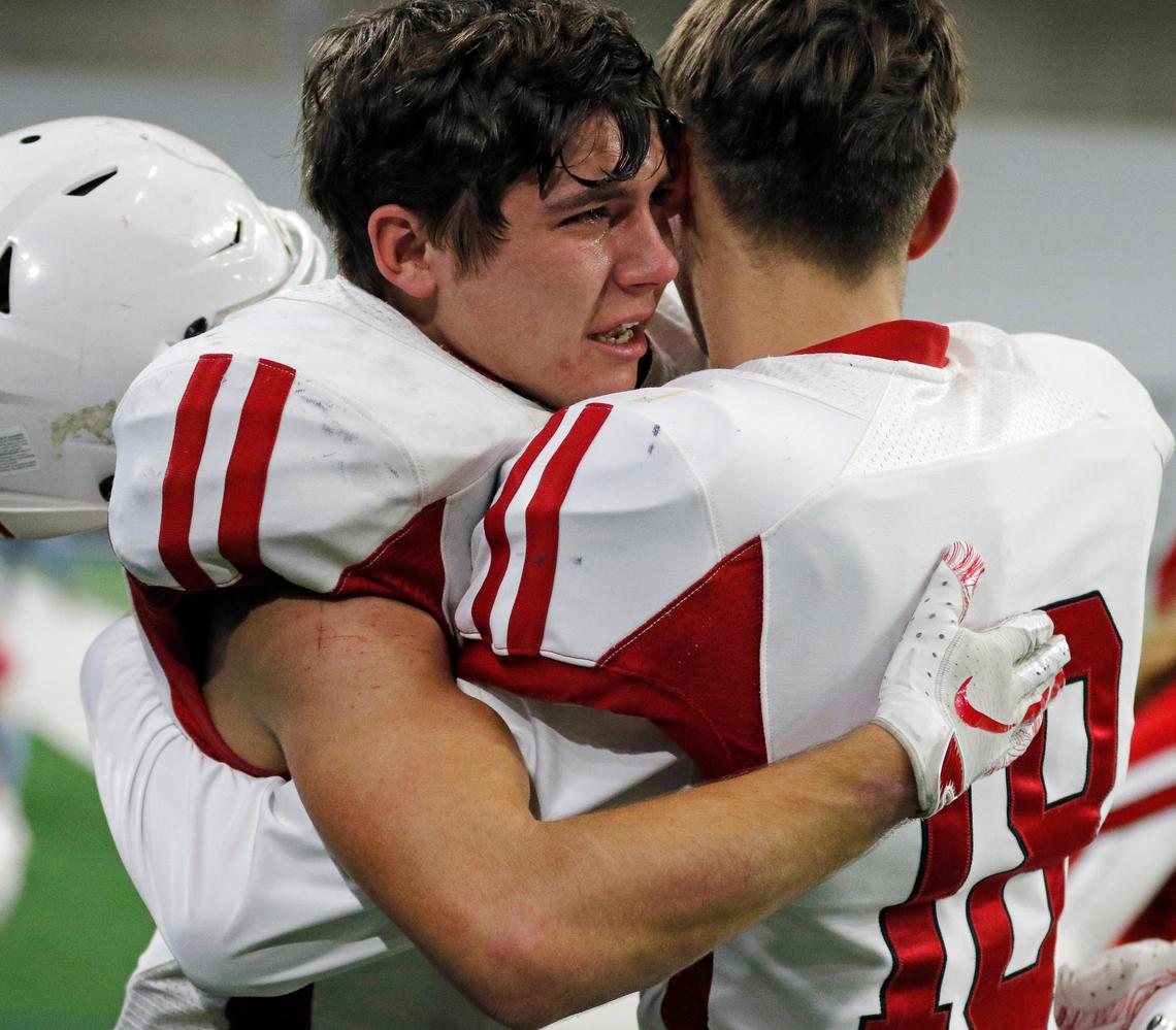 Pottsboro running back Cooper Townsley (8) and wide receiver Grayson Watson (18) embrace after winning the 3A division I state semifinal championship football game at Ford Center in Frisco, Texas, Thursday, Dec. 12, 2019. Pottsboro defeated Brock 36-35. (Special to the Star-Telegram Bob Booth)