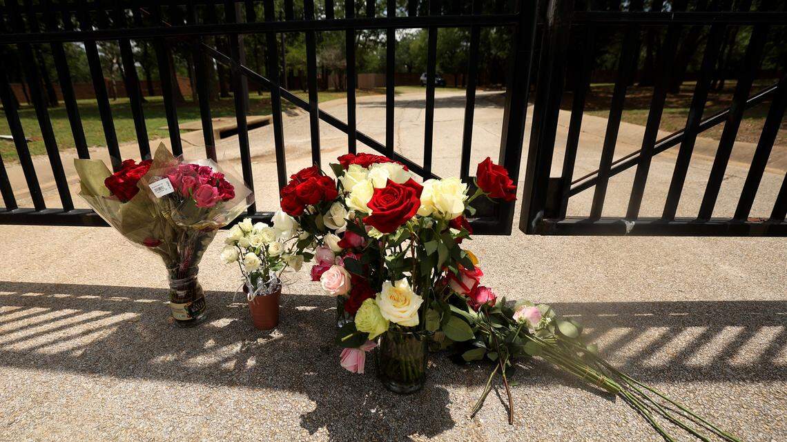 Flowers sit at the gate to the Monastery of the Most Holy Trinity, where the Discalced Carmelite Nuns of Arlington live and pray, on Wednesday, May 31, 2023. Supporters of the sisters placed the flowers outside the monastery after praying at a nearby park. Michael Olson, the Bishop of Fort Worth, has suspended daily activities, including mass and confession.