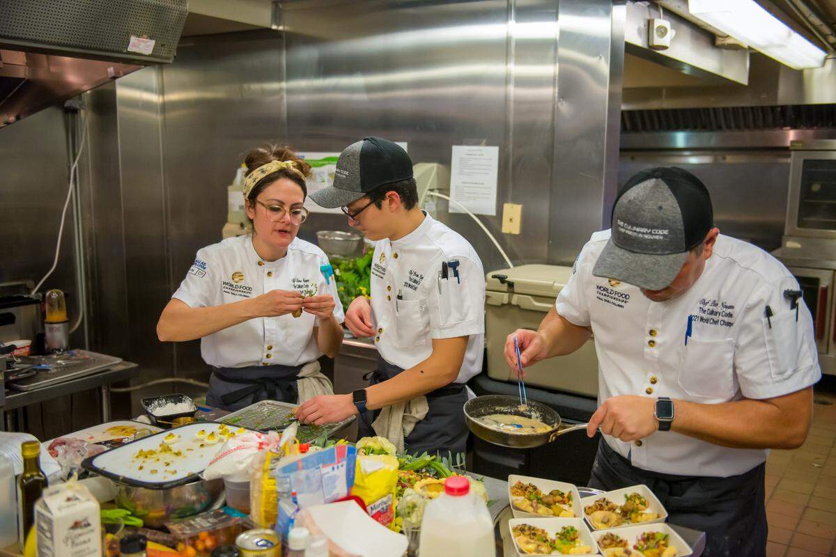 Emma, Preston and Peter Nguyen, work together plating a dish at the World Food Championships “Final Table” in Columbia, South Carolina.