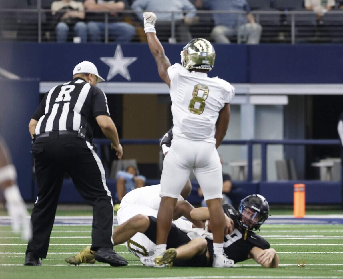 Dallas South Oak Cliff outside linebacker Tramell Minter (8) celebrates their sacking Richmond Randle quarterback Tyler Skrabanek (19) during the first half of the UIL Class 5A Division II championship game on Saturday Dec. 20, 2025 at AT&T Stadium in Arlington, Texas.