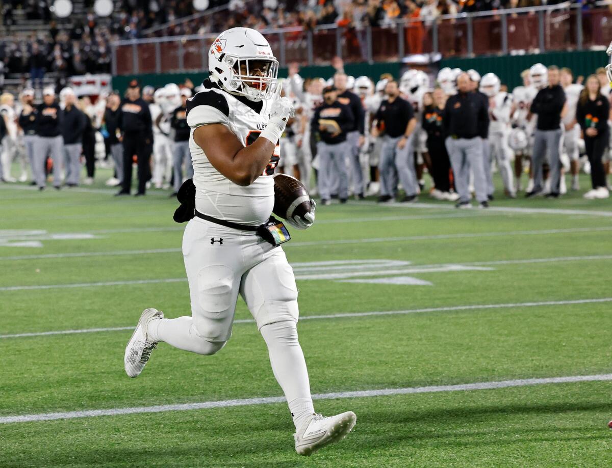 Aledo fullback RJ Blake (25) puts up the silence sign as he scores in the second half of a Conference 5A Division 1 UIL Regional football playoff game at Choctaw Stadium in Arlington, Texas, Friday, Oct. 24, 2023. Aledo defeated Red Oak 59-35.