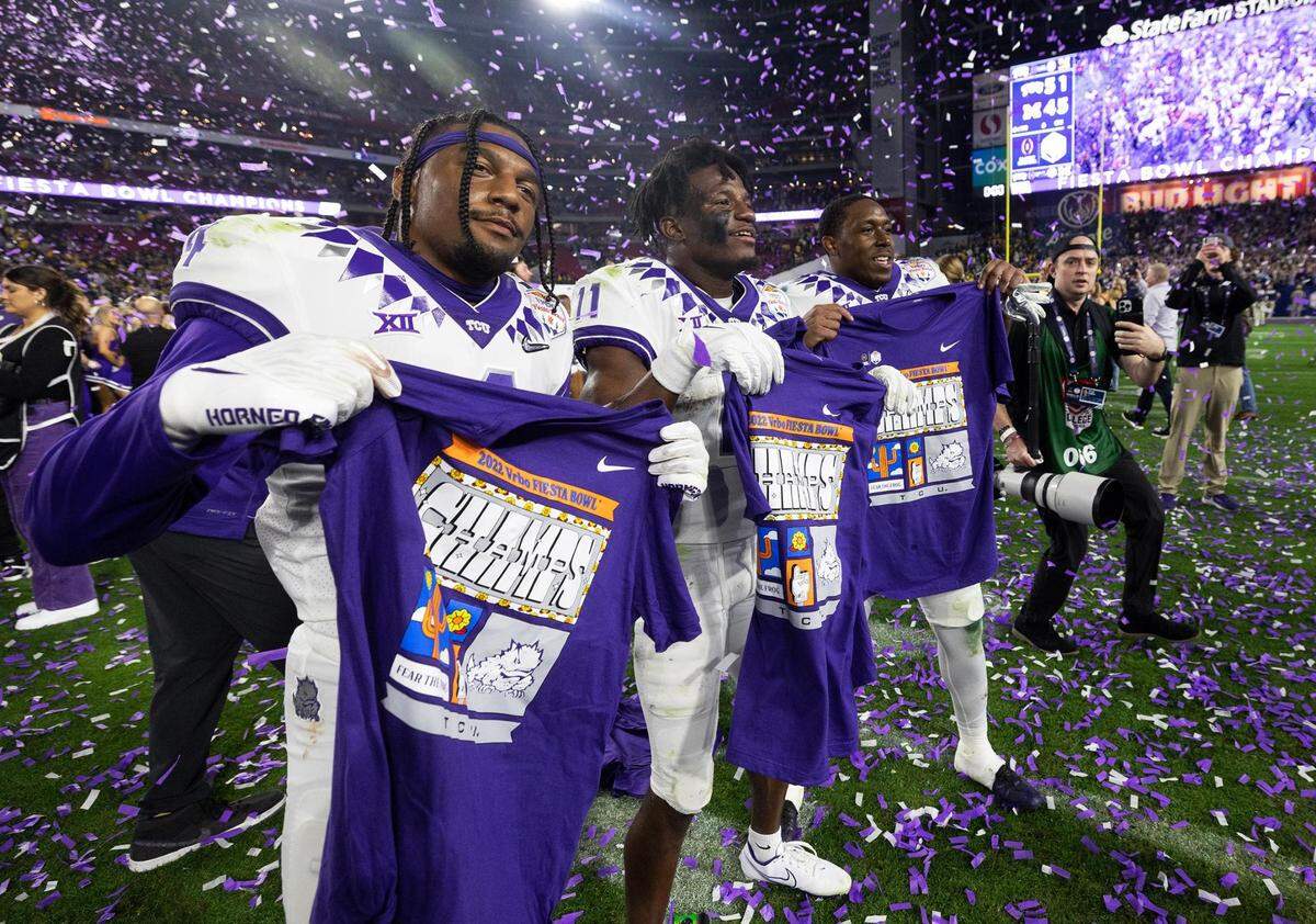 TCU wide receivers Taye Barber, left, Derius Davis, center, and running back Emari Demercado celebrate their win over Michigan to become 2022 Vrbo Fiesta Bowl champs at State Farm Stadium in Glendale, Ariz., on Saturday, December 31, 2022.
